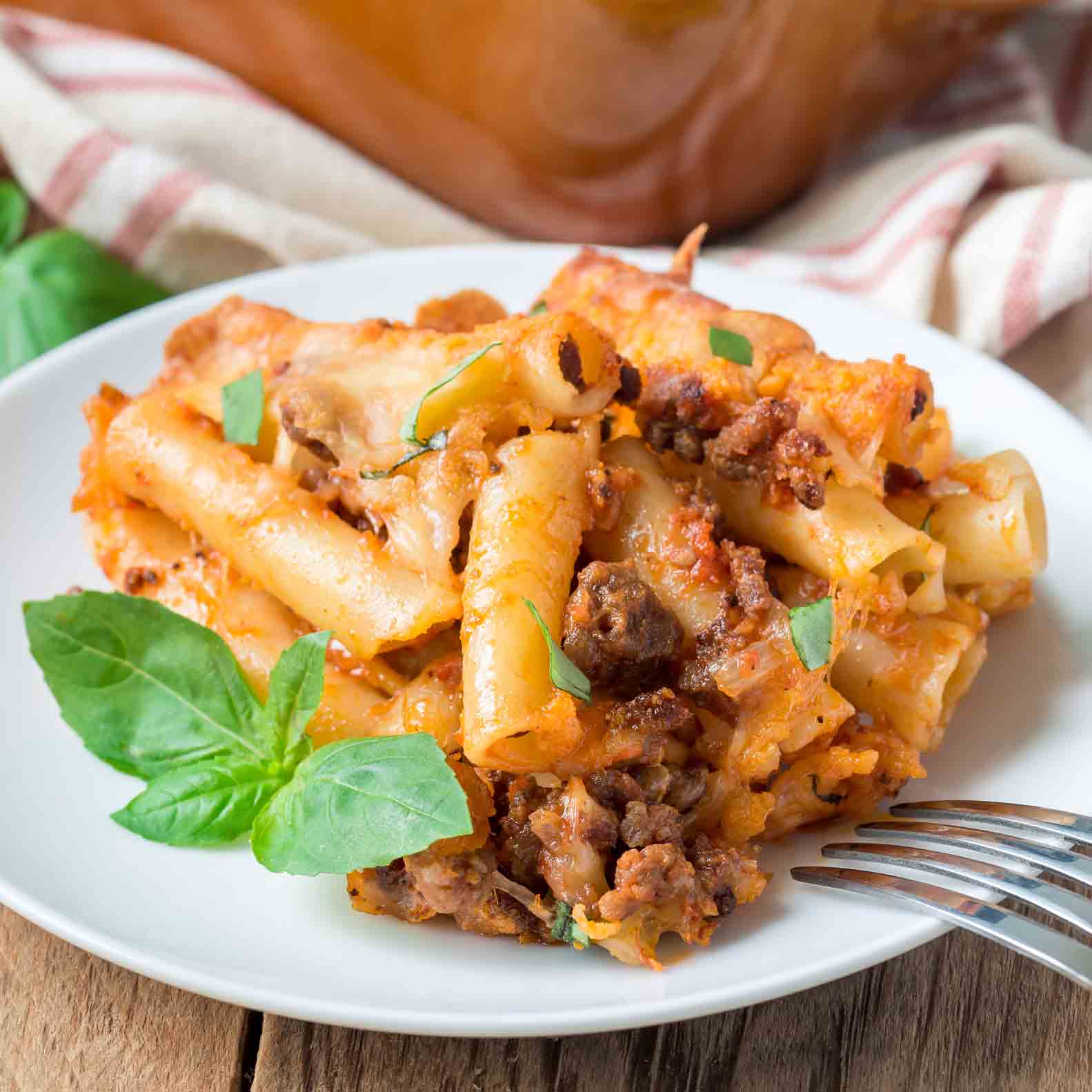 A plate with pasta and meat on it.
